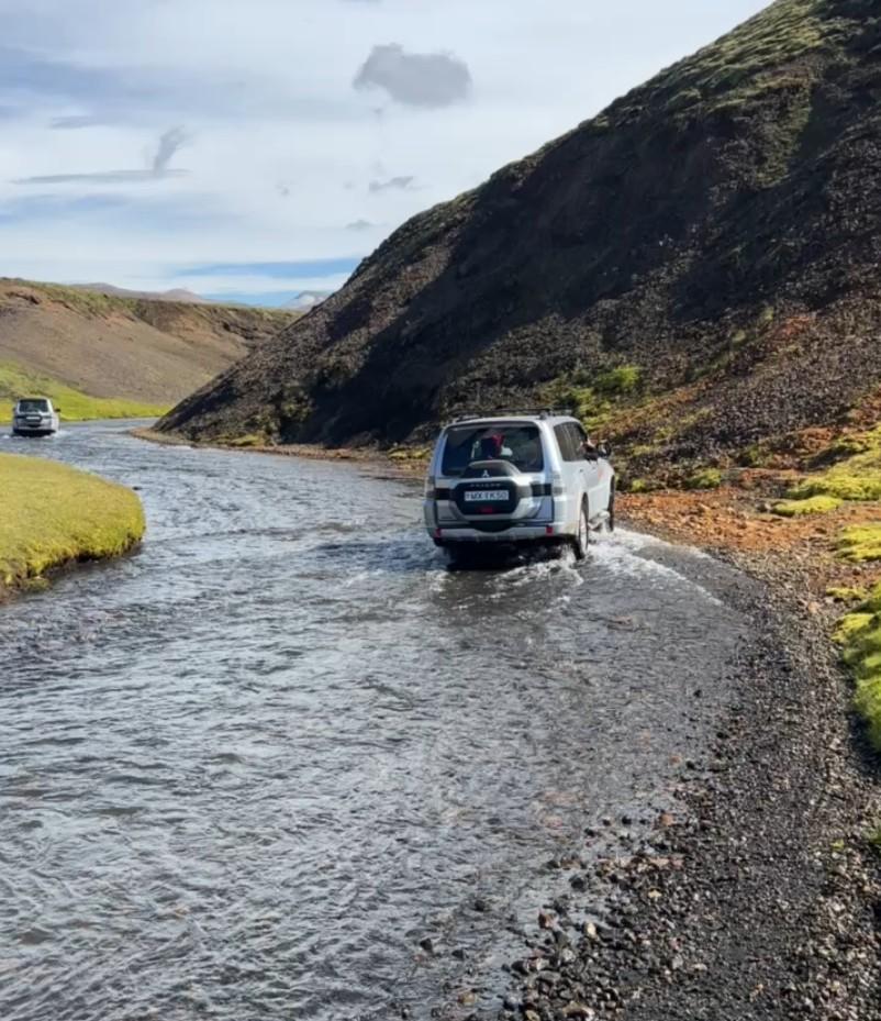 4x4 fording a shallow river on an Icelandic F-road, following the tour route